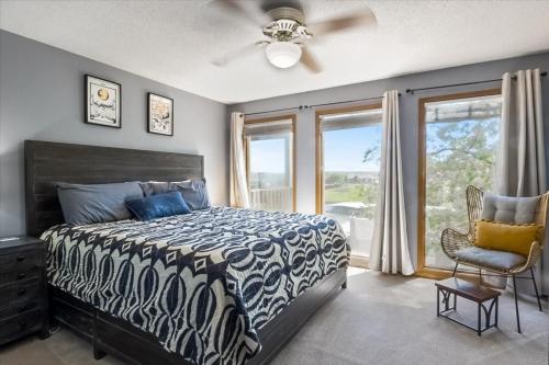 a bedroom with a bed and a window and a chair at Full Moon Condo in Lake Ozark