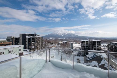 a view of a snow covered mountain from a balcony at Niseko Kyo in Kutchan