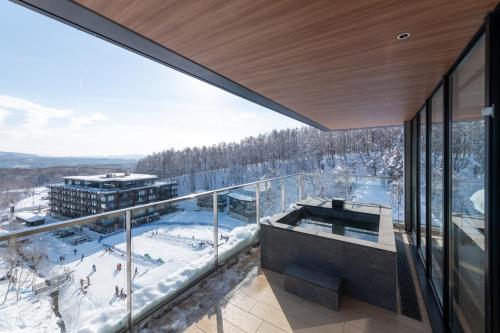 a view from the balcony of a ski resort in the snow at Niseko Kyo in Kutchan