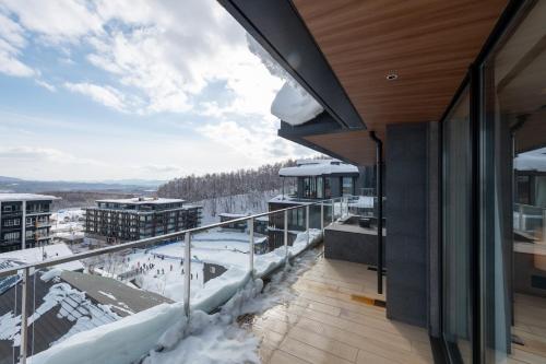 a view from the balcony of a resort in the snow at Niseko Kyo in Kutchan