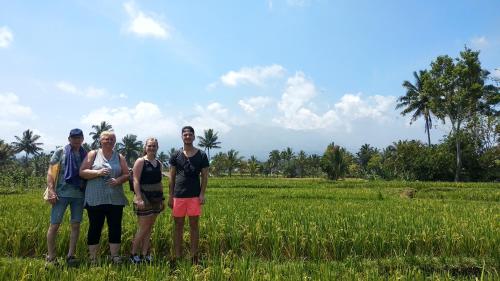 a group of people standing in a field at Alfarizi homestay in Tetebatu