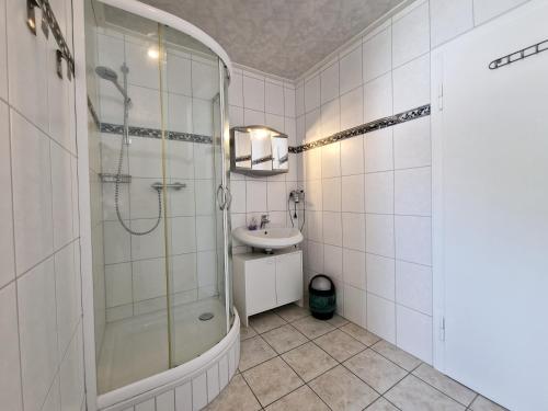 a bathroom with a shower and a sink at Gasthof Zum Burghof in Marsberg