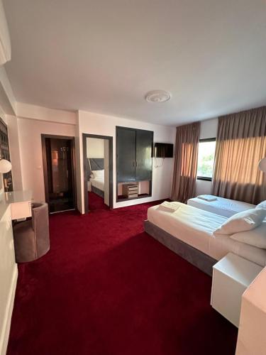 a hotel room with two beds and a red carpet at Crystal boulevard in Tangier