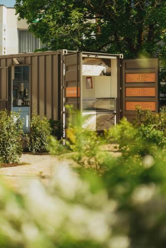 a building with its door open in a garden at 2Places Soul in Lörrach