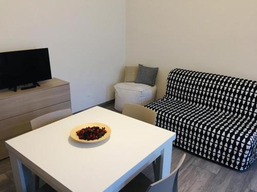 a living room with a white table and a couch at Domus KA 2 in Cremona