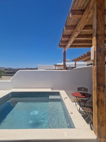 a swimming pool on the side of a house at Casa Philippi Suites in Mikonos