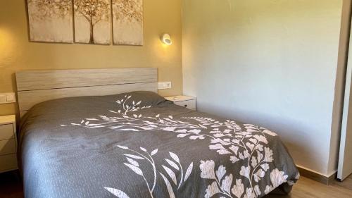 a bedroom with a bed with a black and white blanket at Mas Pigem in Pals