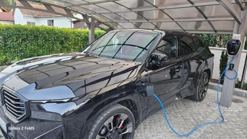 a car is being fueled with a blue hose at Vila Samokres sa bazenom in Banja Koviljača