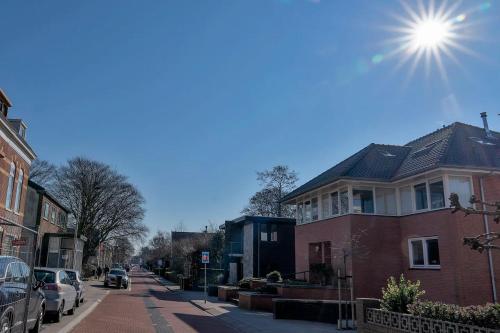 a street with houses and cars parked on the street at Liv Inn Hillegom in Hillegom