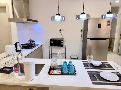 a kitchen with a table with blue shoes on it at MidValley Southkey Mosaic 6-9pax Netflix-SmartTV70inch in Johor Bahru