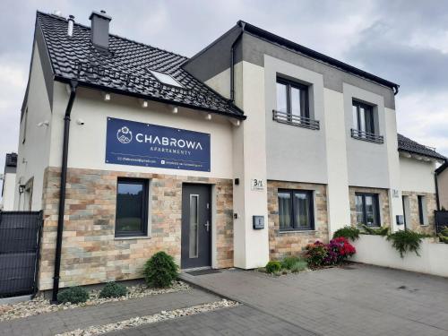 a building with a sign on the front of it at Chabrowa Apartamenty 1 in Milicz