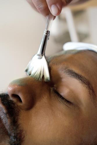 a person getting their eyebrows brushed with a brush at Hotel Santa Teresa by the Beach in Santa Teresa Beach
