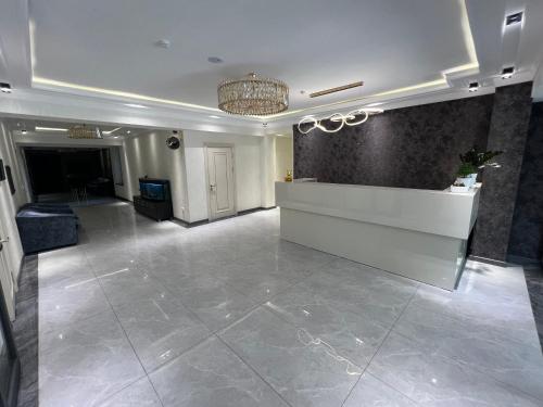 a lobby with a reception desk in a building at DSF GARDEN HOTEL in Yakkasaray