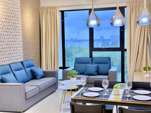 a living room with couches and a table and chairs at MidValley Southkey Mosaic 6-9pax Netflix-SmartTV70inch in Johor Bahru