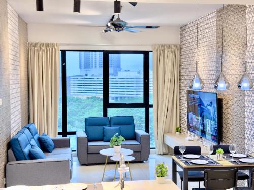a living room with blue furniture and a large window at MidValley Southkey Mosaic 6-9pax Netflix-SmartTV70inch in Johor Bahru