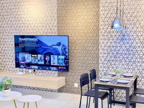 a dining room with a tv on a wall at MidValley Southkey Mosaic 6-9pax Netflix-SmartTV70inch in Johor Bahru