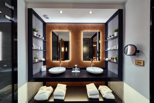 a bathroom with two sinks and a large mirror at La Pyramide - Maison Henriroux in Vienne