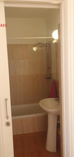 a bathroom with a sink and a tub and a toilet at Evros Peyia & Coral Bay Seaview Apartment in Peyia