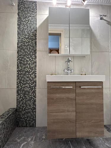 a bathroom with a sink and a mirror at Antiperatos Beach house in Karpathos