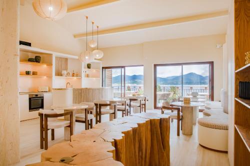 a kitchen and dining room with tables and chairs at Tinah Saint-Tropez in Saint-Tropez