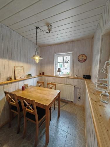 a dining room with a wooden table and chairs at Ferienhaus Fachwerk 99 in Stolberg i. Harz