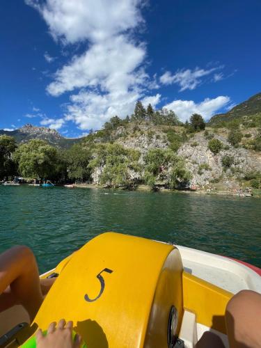a person on a boat in a body of water at "La bâtisse des prés" in Puy-Saint-Vincent