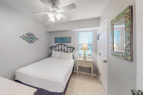 a bedroom with two beds and a ceiling fan at Long Island Village Unit 111 in Port Isabel
