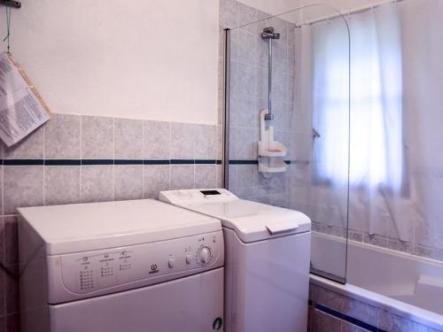 une machine à laver dans une salle de bain avec douche dans l'établissement L'escapade, à Rayol-Canadel-sur-Mer