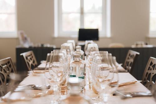 a long table with wine glasses on top of it at Casa Svizzera Agriturismo in Barolo