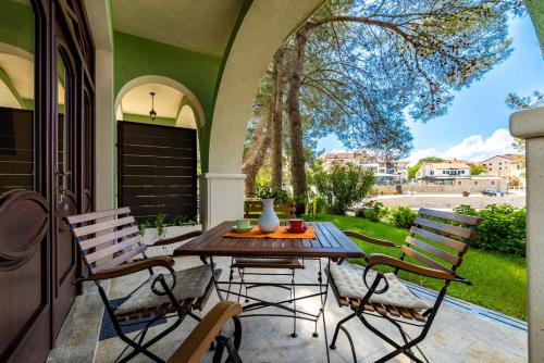 a patio with a table and chairs on a porch at House Dinka with Pool in Porat