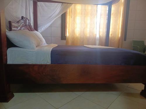 A bed or beds in a room at Oasis Hotel and Guest House. Voi
