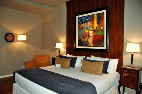 a hotel room with a bed and a painting on the wall at Legado Mitico Buenos Aires in Buenos Aires