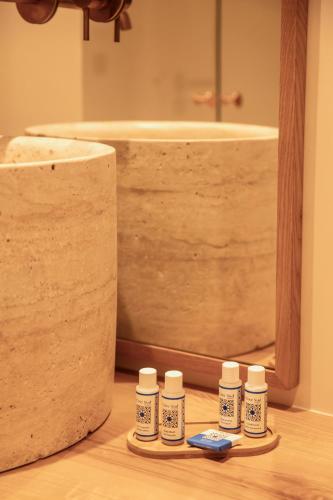 a bathroom with a tub and four bottles of medicine at Tinah Saint-Tropez in Saint-Tropez