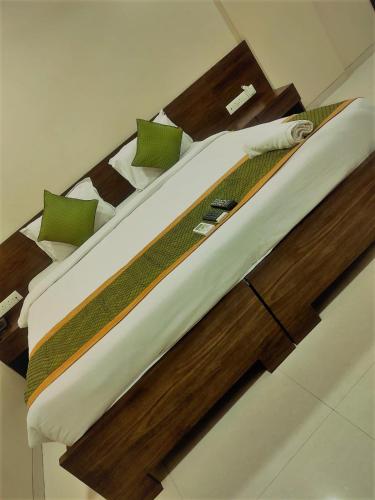 a bed in a room with a wooden headboard at Kedari Residency in Yeraoda