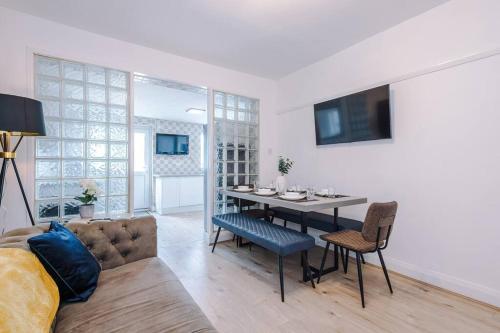 a living room with a table and a couch at Classic 4 Bedroom House in Wirral with WiFi & Parking Sleeps 9 by PureStay in Wirral