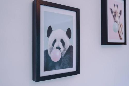 a picture of a dog with a pink tongue at Classic 4 Bedroom House in Wirral with WiFi & Parking Sleeps 9 by PureStay in Wirral