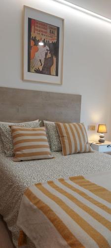 a bedroom with a bed with a poster on the wall at Casa en piedra (Stone House) in Porriño