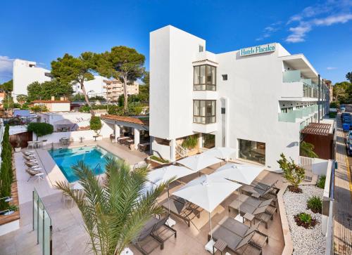 an aerial view of a building with a swimming pool at Flacalco Hotel & Apartments in Cala Ratjada