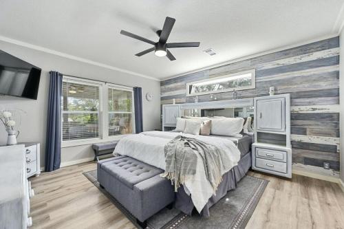 a bedroom with a large bed and a ceiling fan at Sterling Serenity in Austin