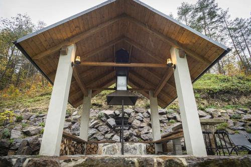 a pavilion with a large roof with a chandelier at Chata pod hradom 1 in Uhrovské Podhradie