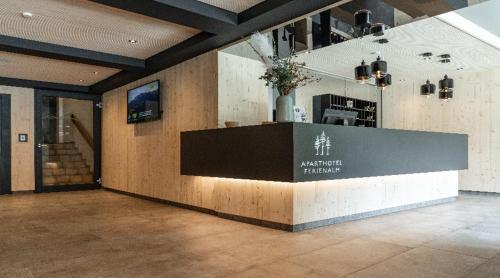 a lobby with a counter in the middle of a building at Ferienalm Panorama Apartments in Schladming