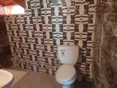 a bathroom with a white toilet and a wall at Belvedere Zakynthos Studios in Vasilikos