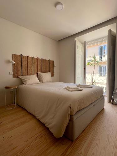 een slaapkamer met een groot bed en een raam bij RIVER VIEW Lisbon Historic Alfama in Lissabon
