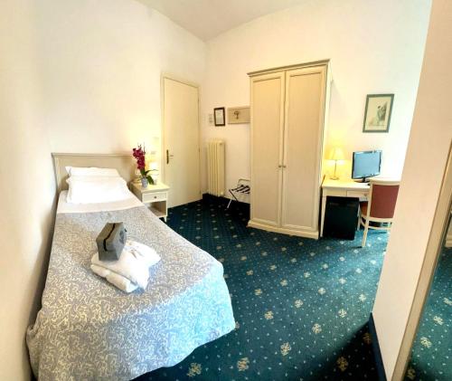 a hotel room with a bed with a teddy bear on it at Terme Villa Pace in Abano Terme