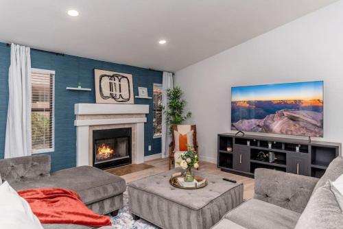 a living room with a fireplace and a tv at Luxury Scottsdale Retreat Heated Pool and Mini Golf in Phoenix