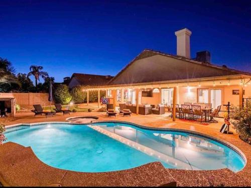 a swimming pool in front of a house at Luxury Scottsdale Retreat Heated Pool and Mini Golf in Phoenix