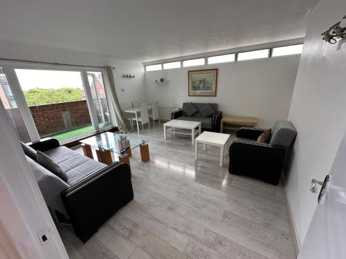 a living room with two couches and a table at Queens Way in London