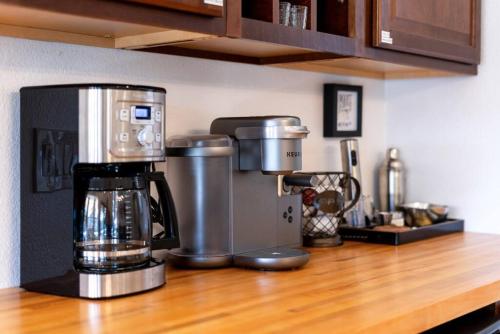 a kitchen counter with a coffee maker on a counter top at Luxury Scottsdale Retreat Heated Pool and Mini Golf in Phoenix