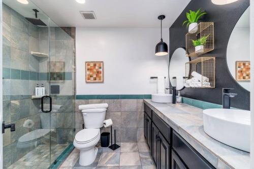 a bathroom with a toilet and a sink at Sunshine, Paradise Escape! Private Pool, Sleeps 12 in Phoenix