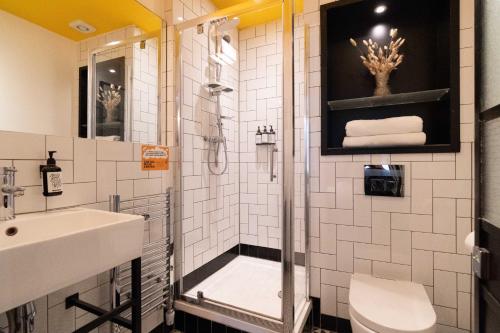 a bathroom with a shower and a sink and a toilet at room2 Hammersmith Townhouse in London